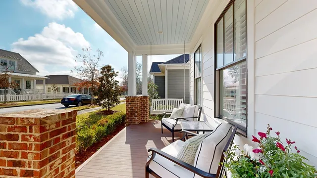 a balcony with furniture and a potted plant