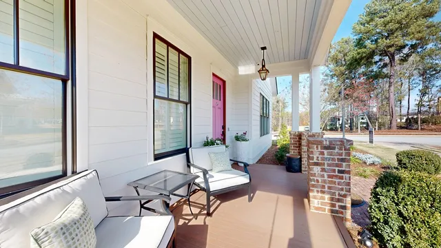 a balcony with furniture and a potted plant