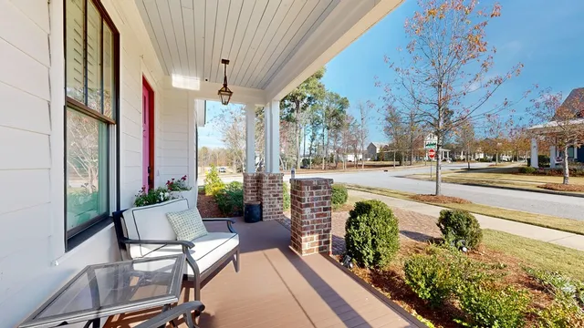 a view of a patio with couches table and chairs and potted plants