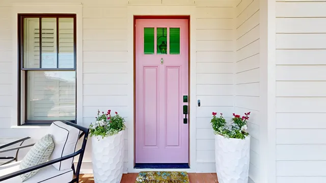 a view of a house with potted plants