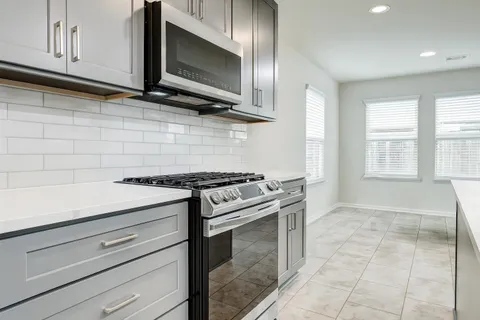a view of a kitchen with kitchen island wooden cabinets and center island