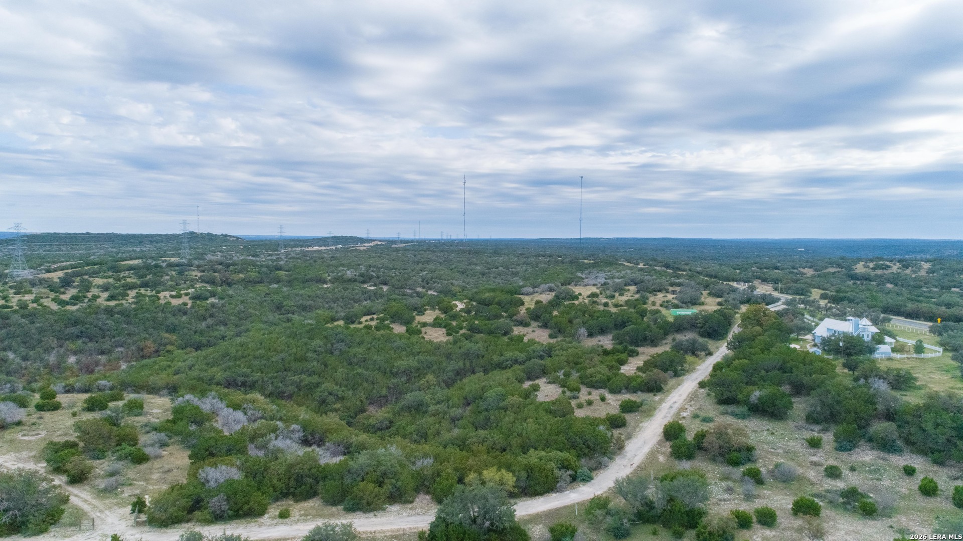 1985 State Loop 481 Junction, TX 76849 - Photo 17 of 37 an aerial view of residential houses with outdoor space and trees