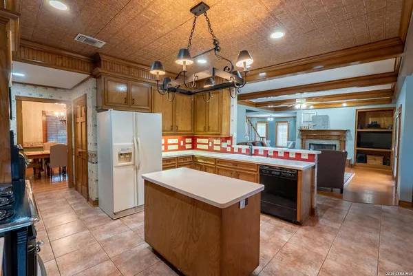 a kitchen with refrigerator and cabinets