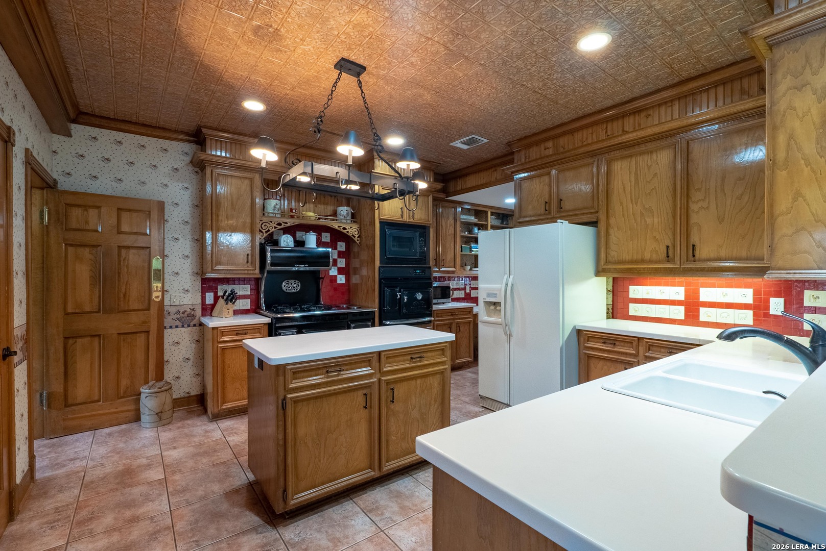 1985 State Loop 481 Junction, TX 76849 - Photo 21 of 37 a kitchen with refrigerator and cabinets