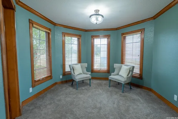 a spacious bedroom with a bed and a chandelier