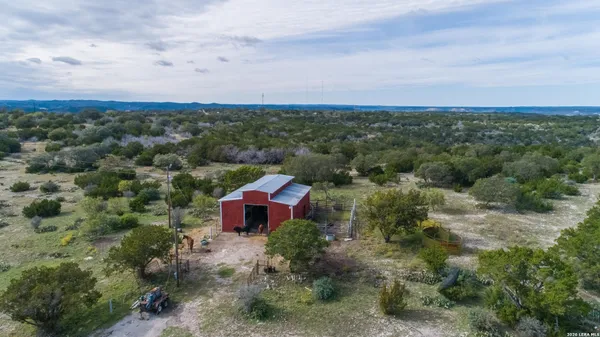 an aerial view of houses covered in trees