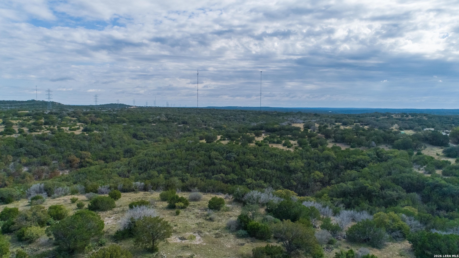 1985 State Loop 481 Junction, TX 76849 - Photo 9 of 37 an aerial view of residential houses with outdoor space and trees