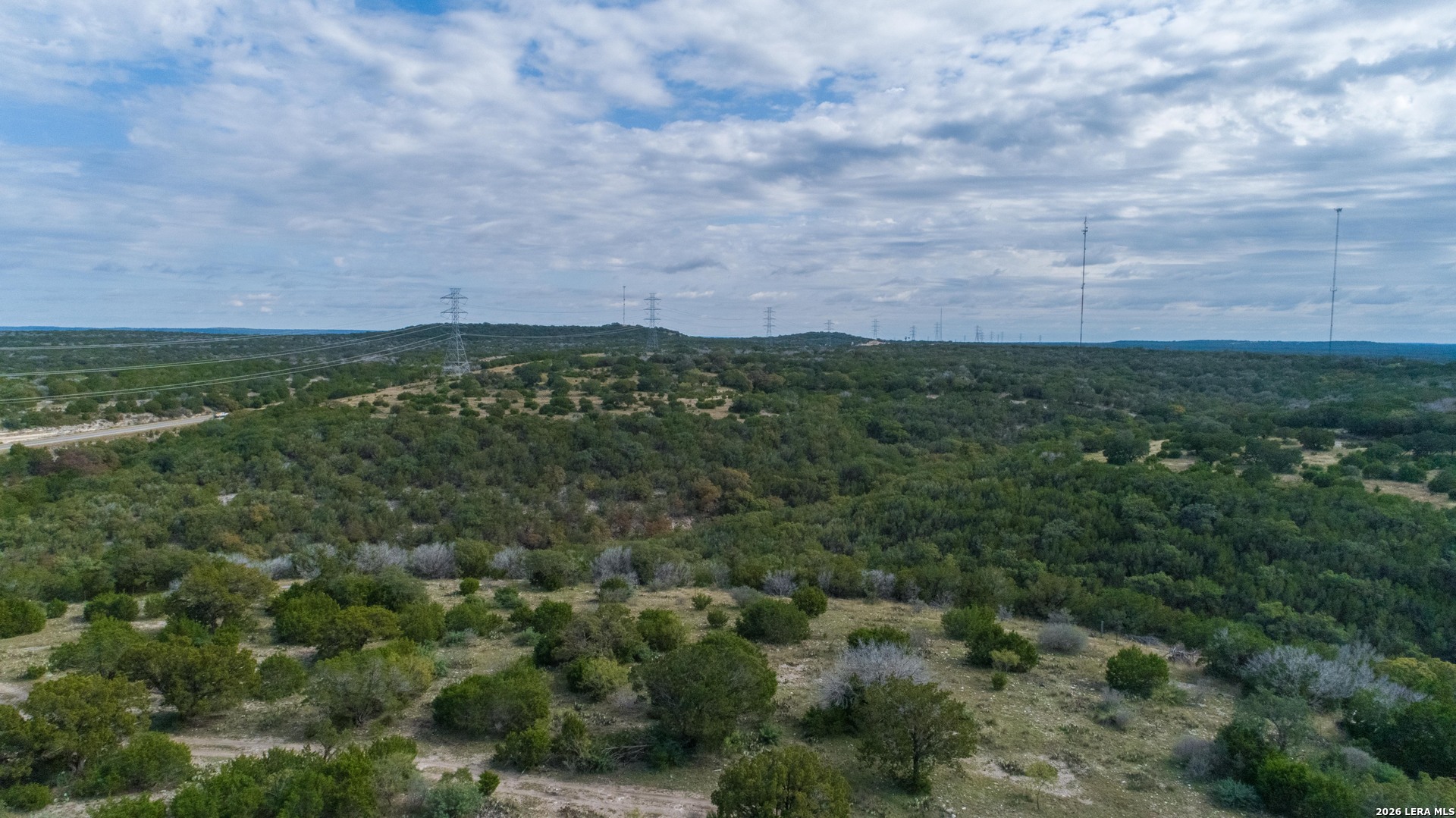 1985 State Loop 481 Junction, TX 76849 - Photo 10 of 37 an aerial view of residential houses with outdoor space and trees