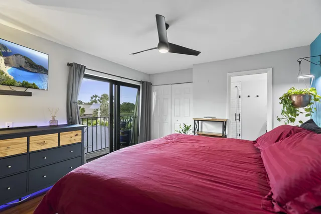 a bedroom with a bed and a large window