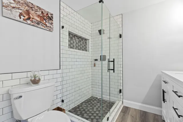 a bathroom with a toilet and shower