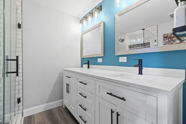a bathroom with a sink vanity and a mirror