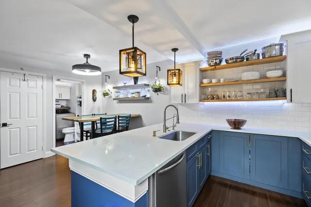 a kitchen with kitchen island a sink counter space and a window