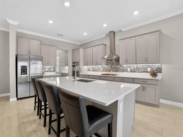 a en suite bathroom with a double vanity sink a mirror and a shower