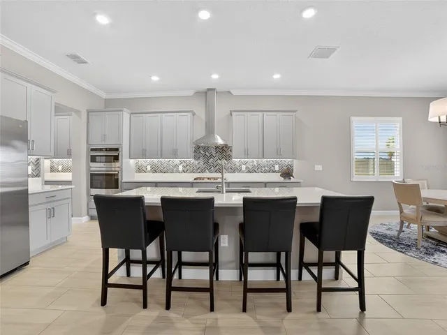 a spacious bedroom with a bed and a chandelier
