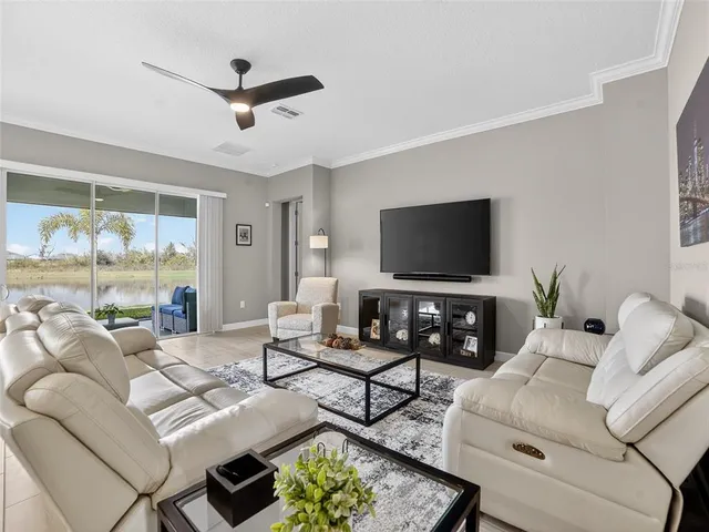 a living room with furniture and a glass door