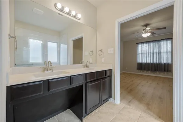 a bathroom with a sink double vanity and a mirror