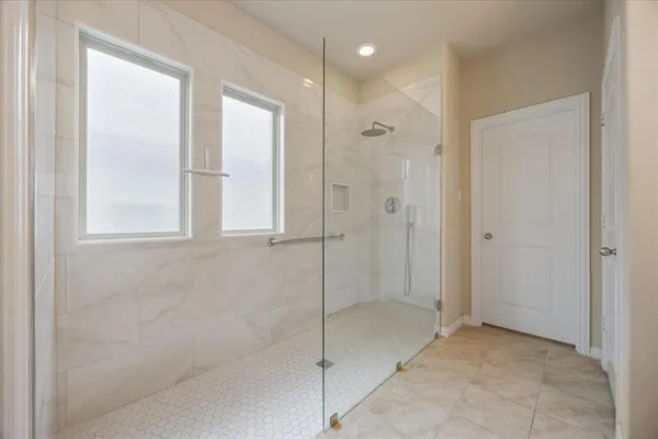 a bathroom with a glass shower door