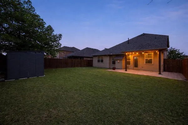 a view of an house with backyard space and garden