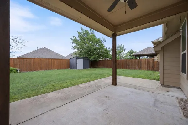 a view of a house with a big yard and garage
