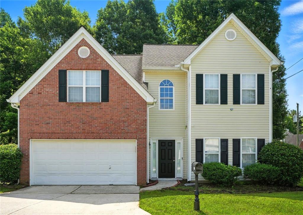 5487 Walnut Lane Lithonia, GA 30038 - Photo 1 of 43 a front view of a house with a yard and garage