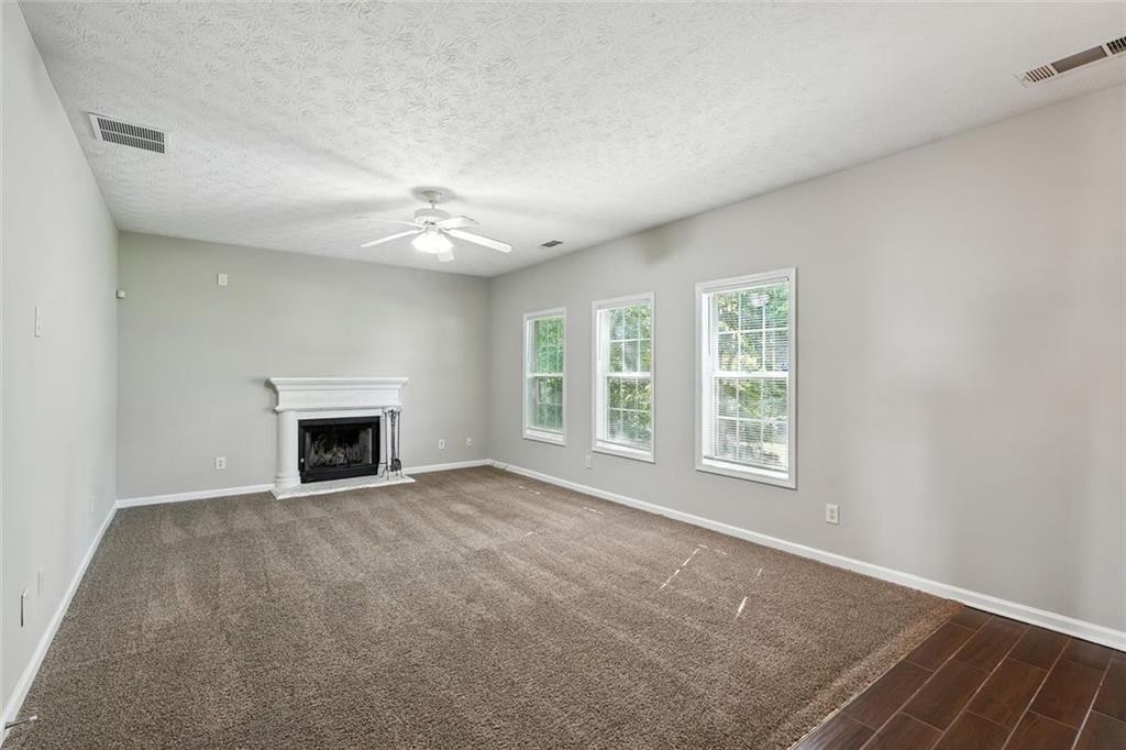5487 Walnut Lane Lithonia, GA 30038 - Photo 16 of 43 an empty room with windows and fireplace