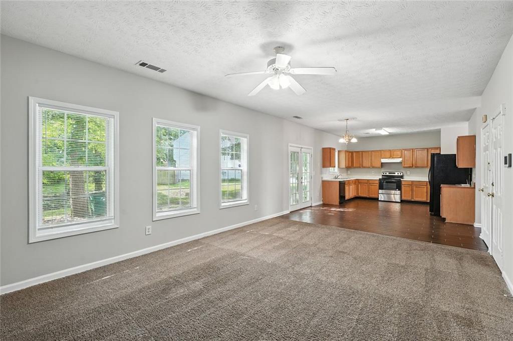 5487 Walnut Lane Lithonia, GA 30038 - Photo 17 of 43 a view of an empty room with kitchen view and a window
