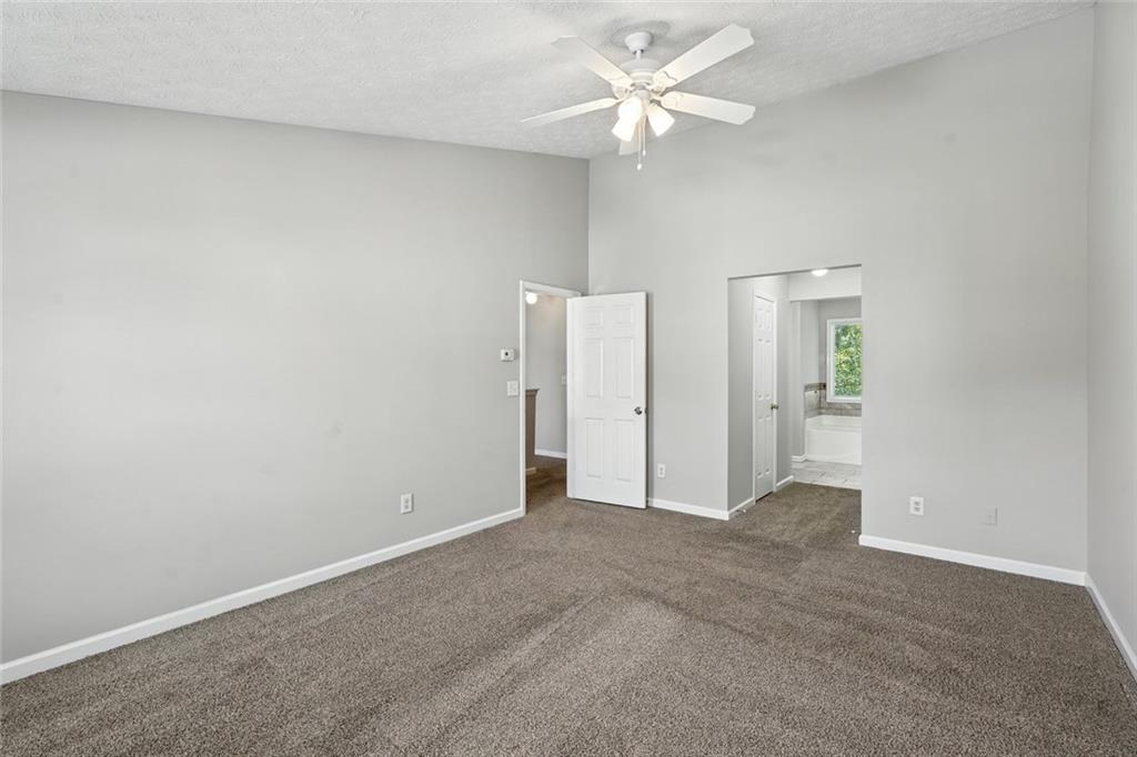 5487 Walnut Lane Lithonia, GA 30038 - Photo 20 of 43 an empty room with closet and a ceiling fan