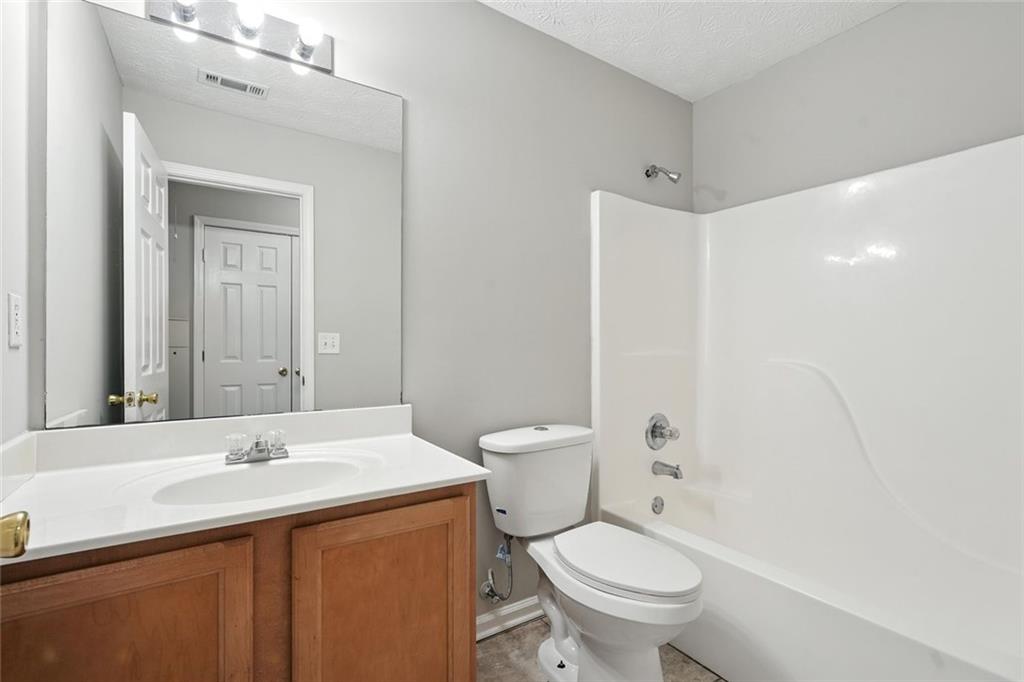 5487 Walnut Lane Lithonia, GA 30038 - Photo 33 of 43 a bathroom with a sink toilet and shower