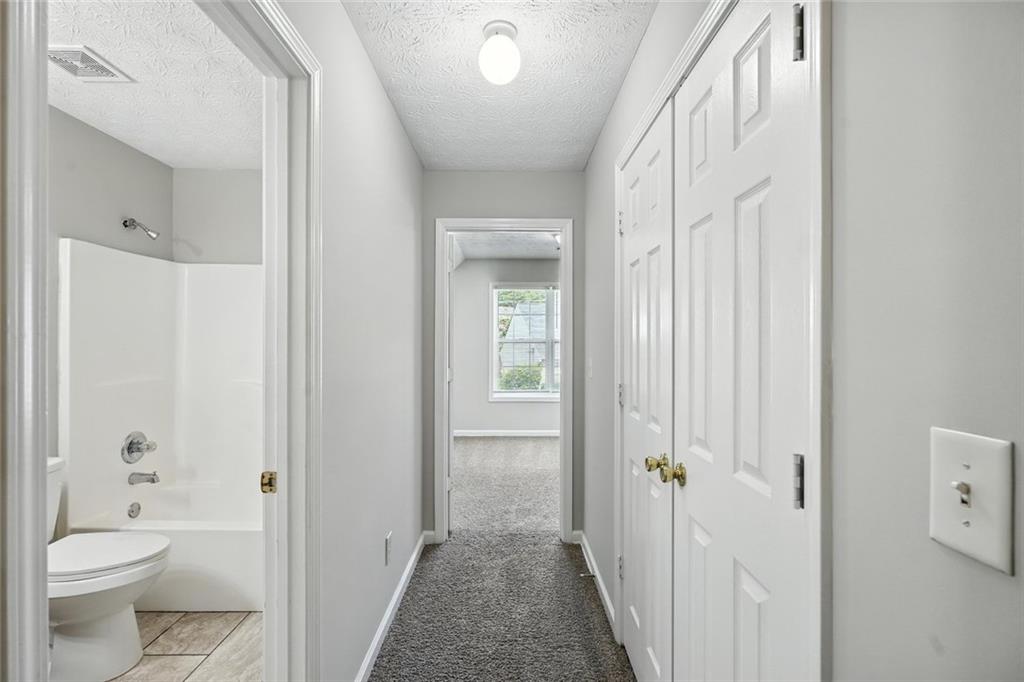 5487 Walnut Lane Lithonia, GA 30038 - Photo 34 of 43 a bathroom with a granite countertop sink a toilet and shower