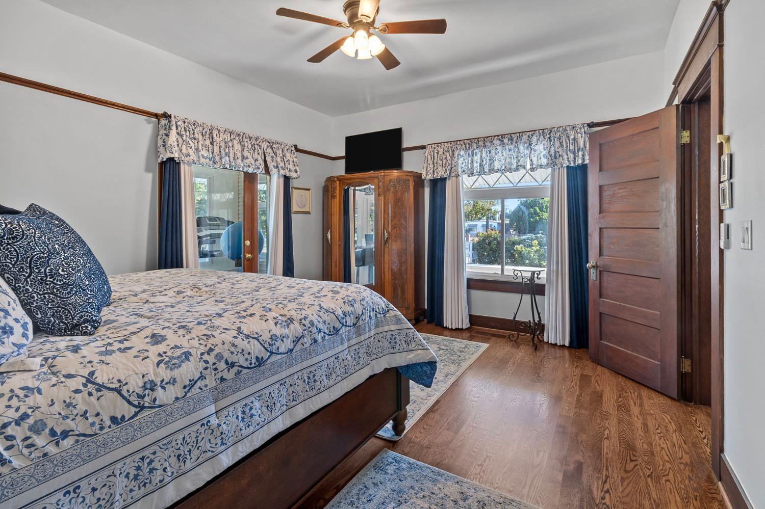 5237 Crows Landing Road Modesto, CA 95358 - Photo 29 of 87 a spacious bedroom with a balcony a bed and a chandelier