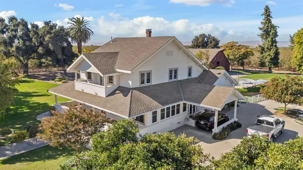 an aerial view of a house with a yard