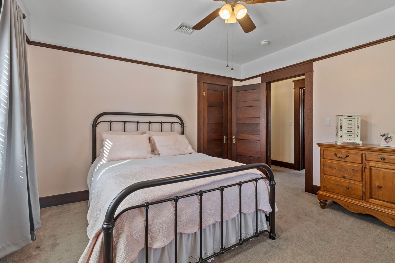 5237 Crows Landing Road Modesto, CA 95358 - Photo 39 of 87 a bedroom with a bed and a chandelier