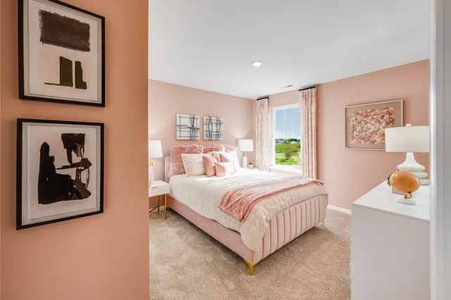 a bedroom with a bed and painting on the wall