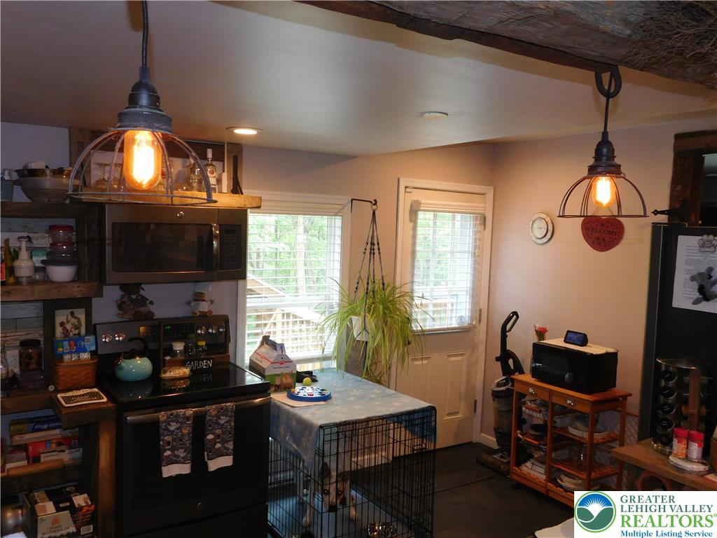 41 Reeder Street Mount Pocono, PA 18344 - Photo 35 of 41 An inviting kitchen features warm lighting, practical appliances, and a convenient back door access.