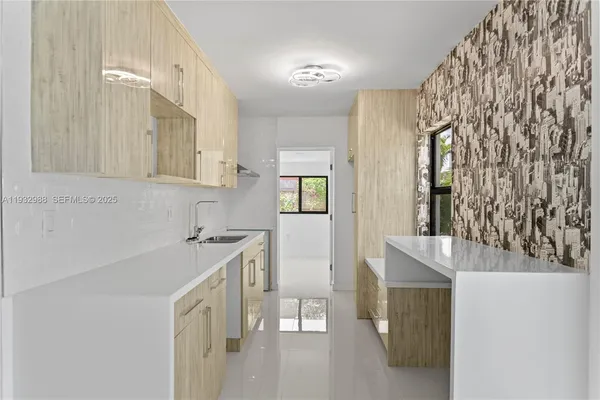 a kitchen with stainless steel appliances a refrigerator and a sink