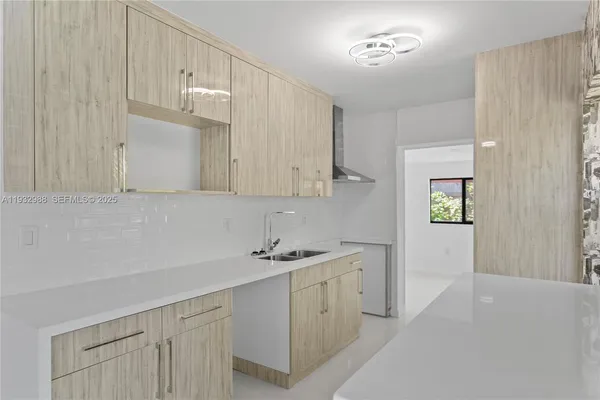 a kitchen with cabinets and window