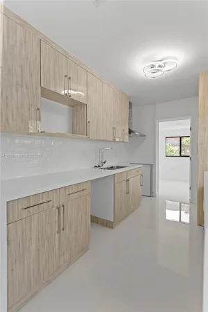 a kitchen with white cabinets and white appliances