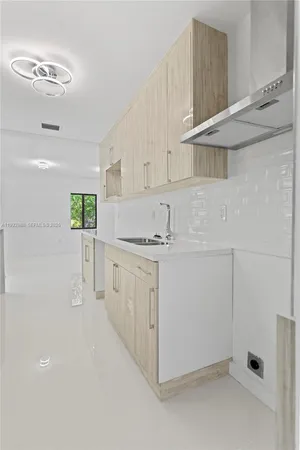 a bathroom with a window sink and mirror