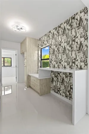 an empty room with windows and closet