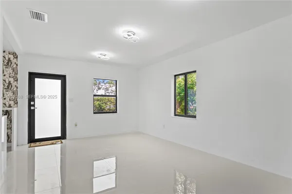 a view of a hallway with bathroom