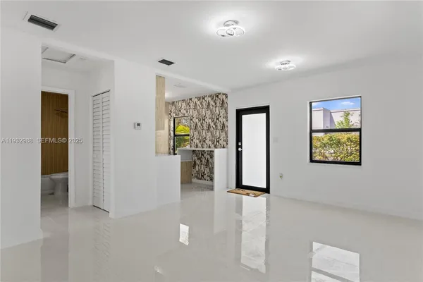a view of an entryway with wooden floor