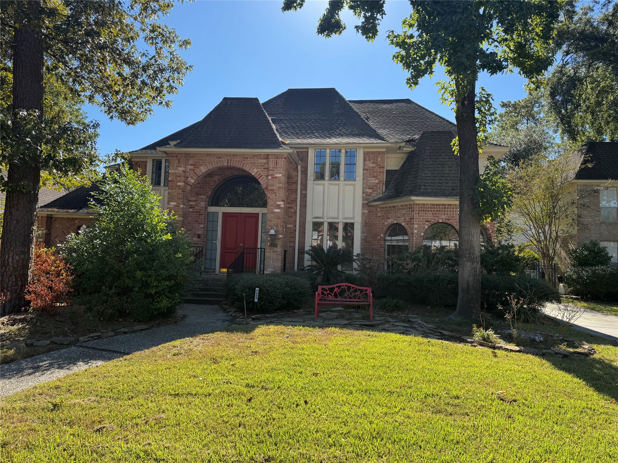 a front view of a house with yard and trees