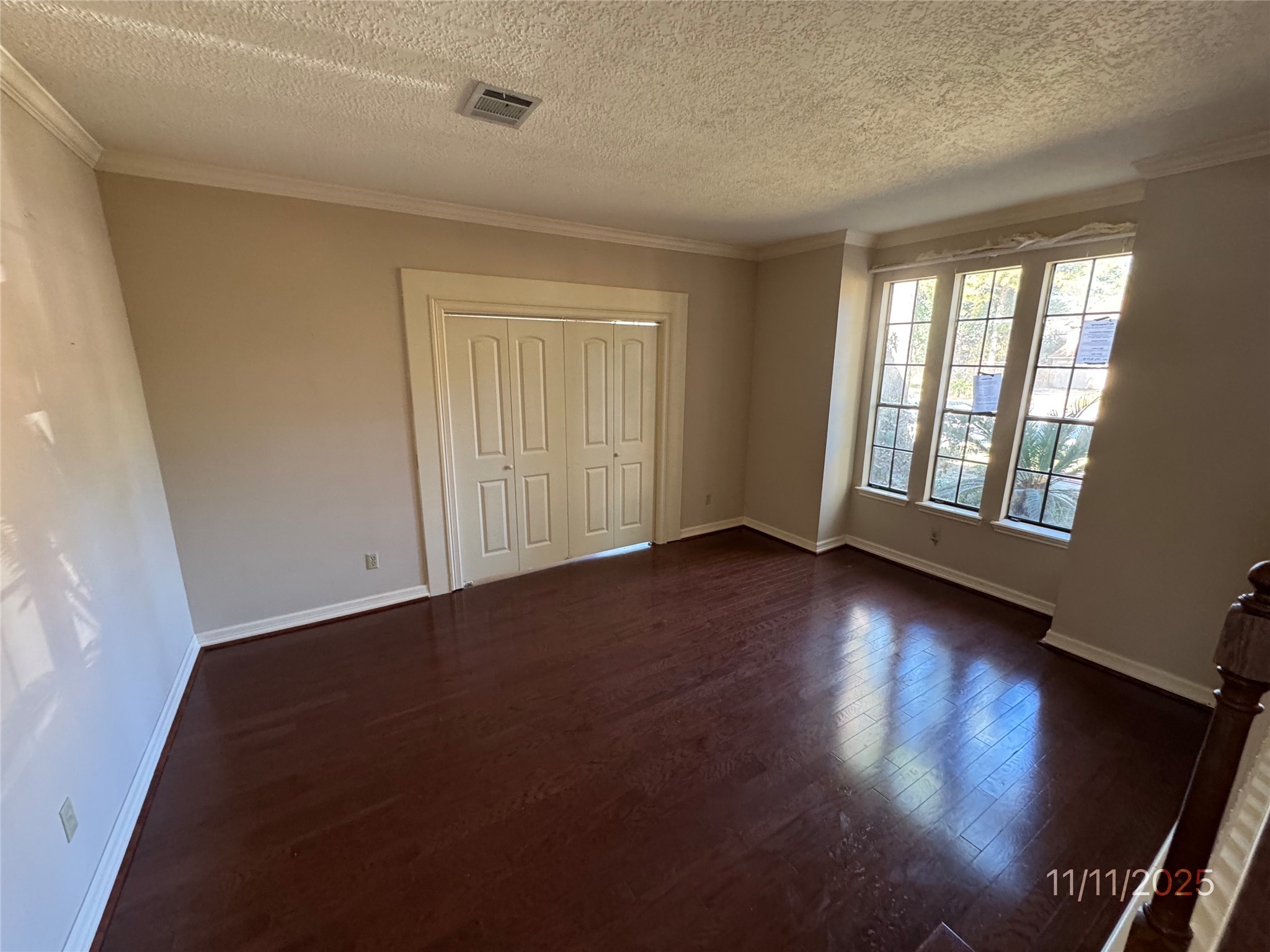 5223 Charnwick Court Houston, TX 77069 - Photo 4 of 28 an empty room with wooden floor and windows with curtains view