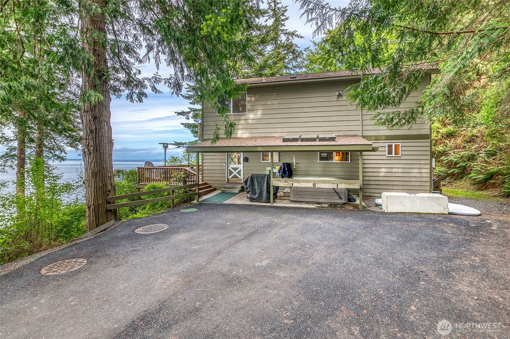 673 Raccoon Point Road Orcas Island, WA 98245 - Photo 8 of 40 a view of a house with a yard and garage
