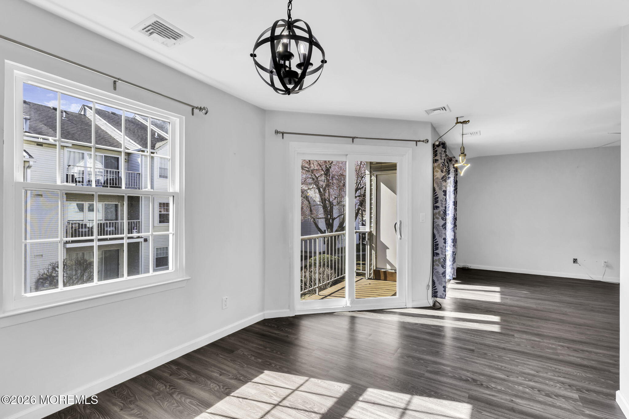 231 Atlantic Street, Unit 55 Keyport, NJ 07735 - Photo 11 of 31 a view of empty room with wooden floor and fan