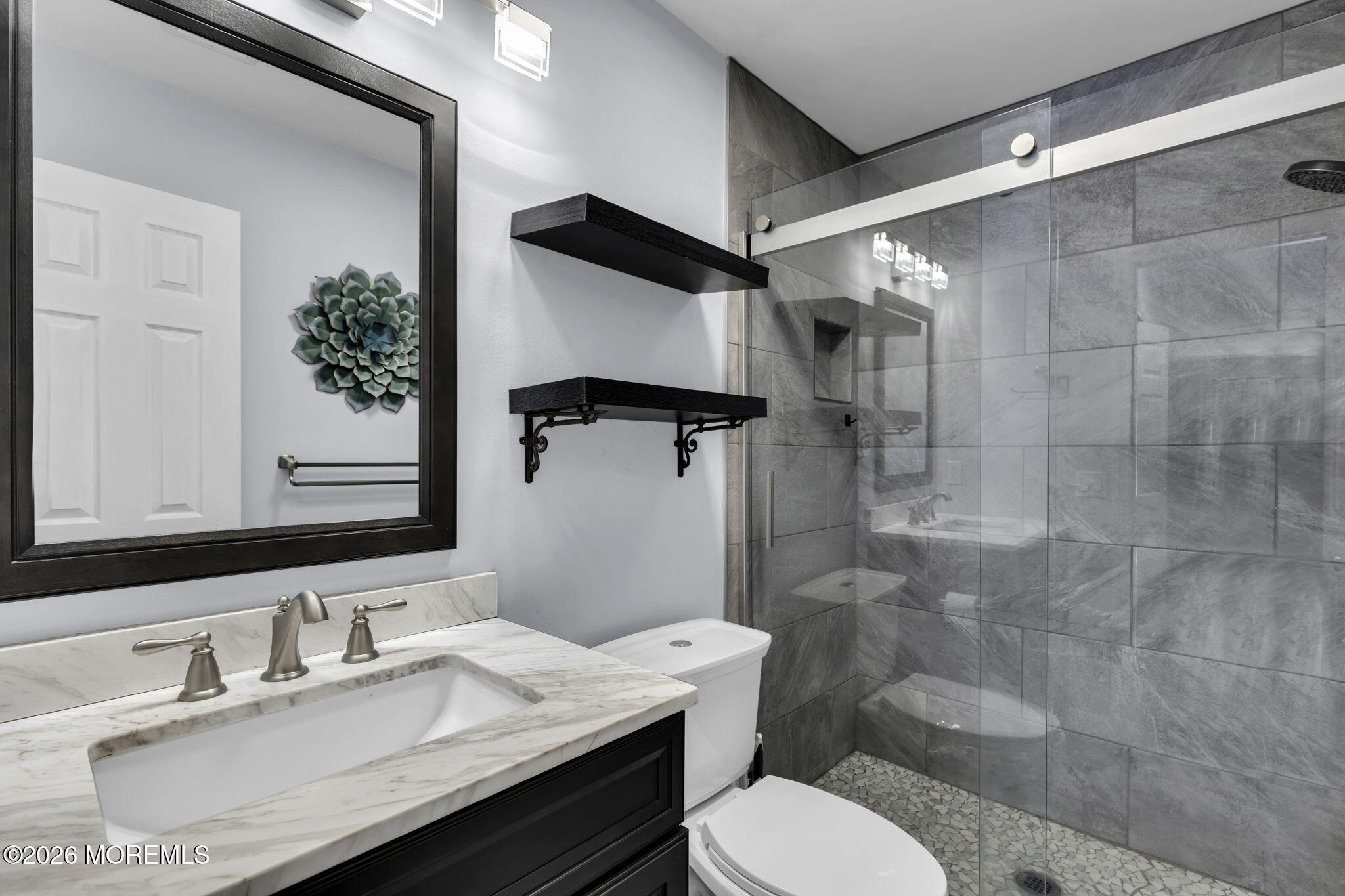 231 Atlantic Street, Unit 55 Keyport, NJ 07735 - Photo 17 of 31 a bathroom with a granite countertop sink toilet a mirror and shower