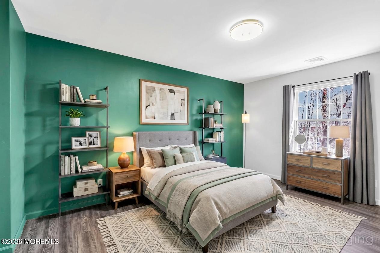 231 Atlantic Street, Unit 55 Keyport, NJ 07735 - Photo 20 of 31 a bedroom with a bed a dresser and book shelf