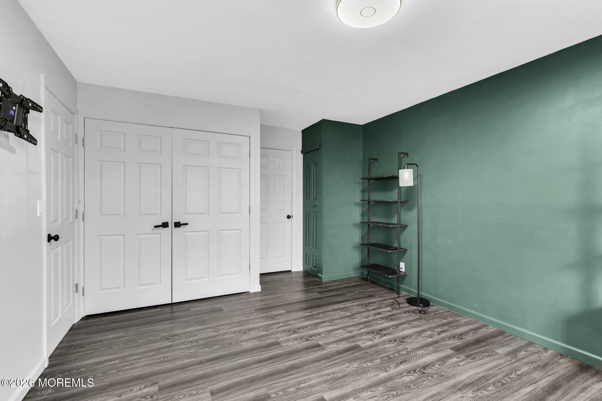 231 Atlantic Street, Unit 55 Keyport, NJ 07735 - Photo 21 of 31 a view of an empty room with closet and wooden floor