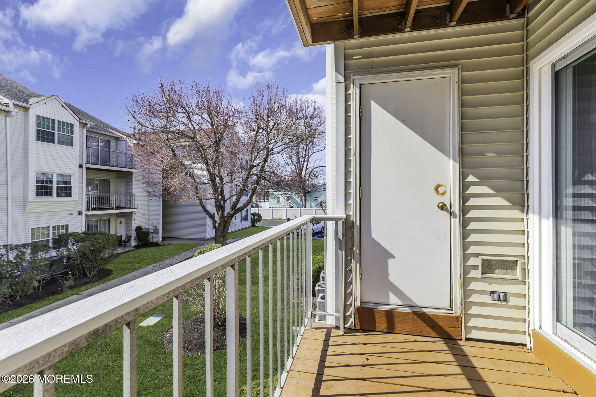231 Atlantic Street, Unit 55 Keyport, NJ 07735 - Photo 27 of 31 a view of a balcony with wooden floor and stairs