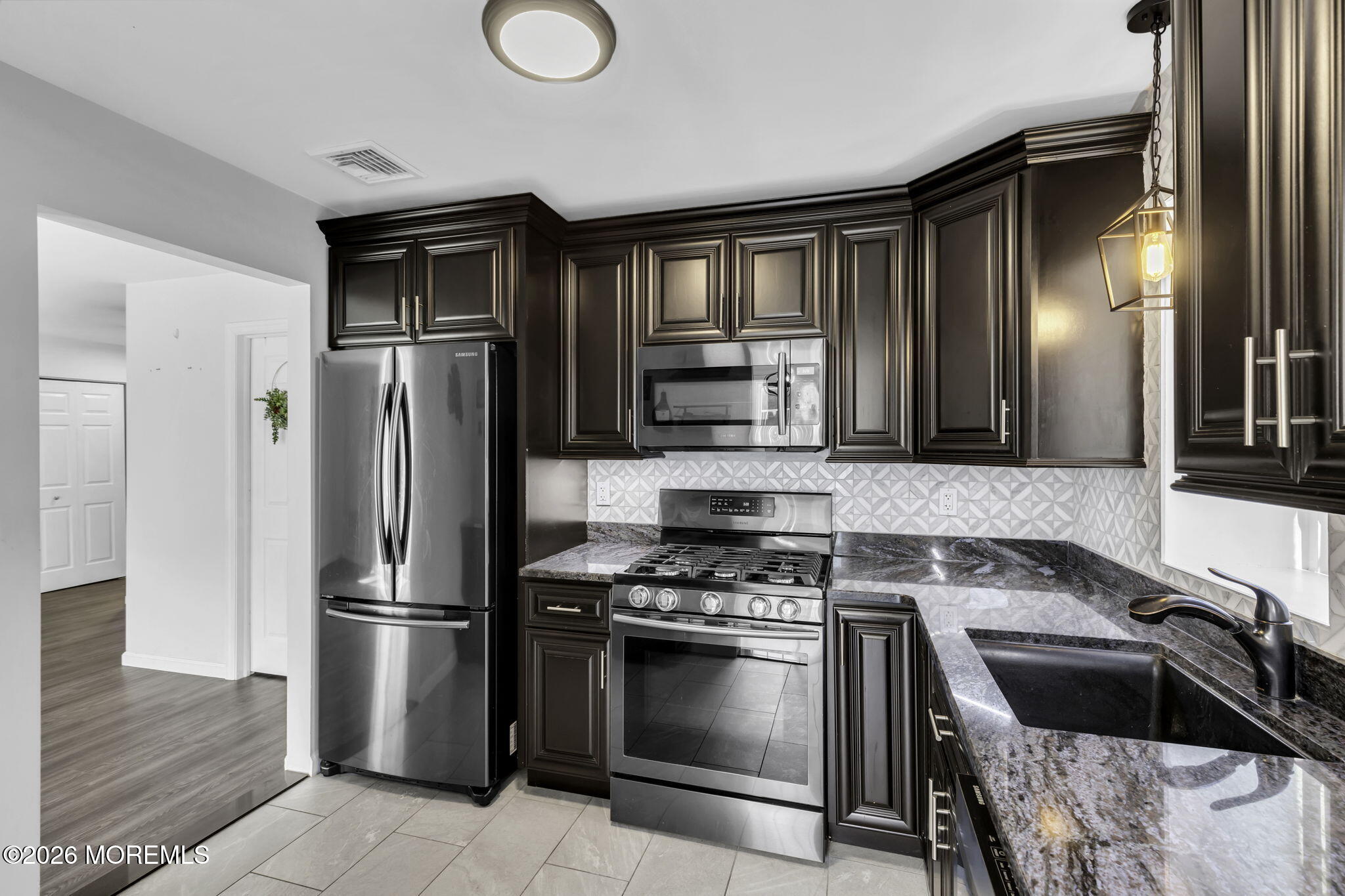231 Atlantic Street, Unit 55 Keyport, NJ 07735 - Photo 3 of 31 a kitchen with a refrigerator stove and sink